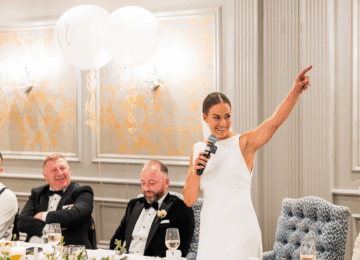 Elegant hotel banquet with well-dressed guests enjoying a stylish event, featuring luxurious décor and ambient lighting.