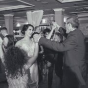 Guests enjoying a lively dance in the elegant hotel ballroom with chandeliers and luxurious decor. Perfect venue for events.