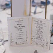 Elegant hotel table setting with a wedding menu, fine dining setup, and welcoming atmosphere for special events.