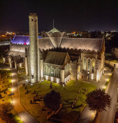 Night view of historic, illuminated cathedral near hotel, showcasing stunning architecture and vibrant city surroundings.