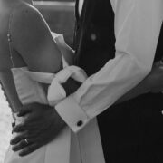 Elegant wedding couple embracing in sunlit courtyard, showcasing hotel’s romantic and serene outdoor spaces.
