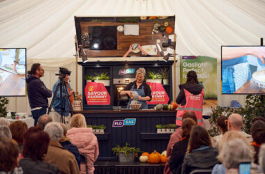 Cooking demo at lively hotel event with audience and charming decor, showcasing culinary skills and local flavours.