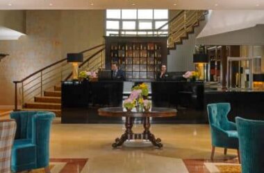 Elegant hotel lobby with plush seating, grand chandelier, and welcoming reception desk for a luxurious stay experience.